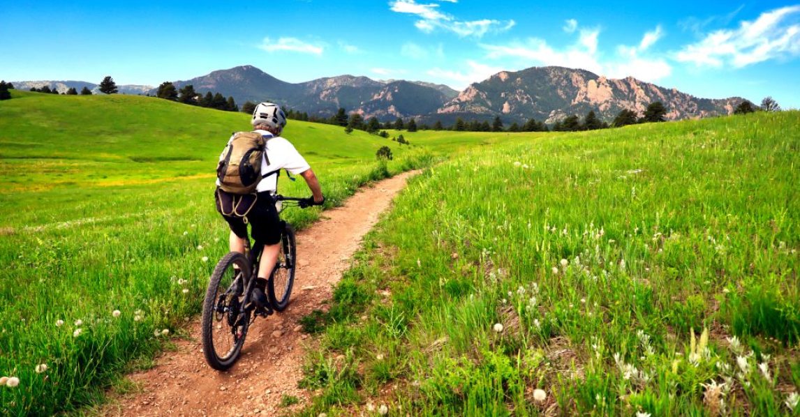 Mountain biker rides the Flatirons VIsta Trail near Boulder, Colorado